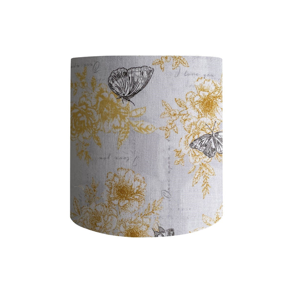 Cylinder style, 25cm x 25cm  lampshade with summer romance fabric with yellow flowers, black etched butterflies on a white background, handcrafted by shades at grays.