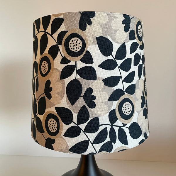 Handcrafted lampshade by shades at grays with graphic bloom fabric, unlit.