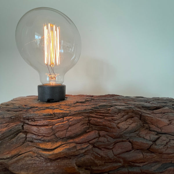 Reclaimed wood table lamp, with deep wave eroded grooves and edison bulb by  Shades at Grays, close up.