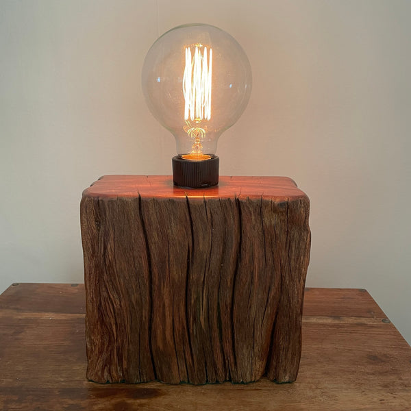 Wood table lamp made from upcycled wharf timber and replica edison bulb, lit, handcrafted by shades at grays.