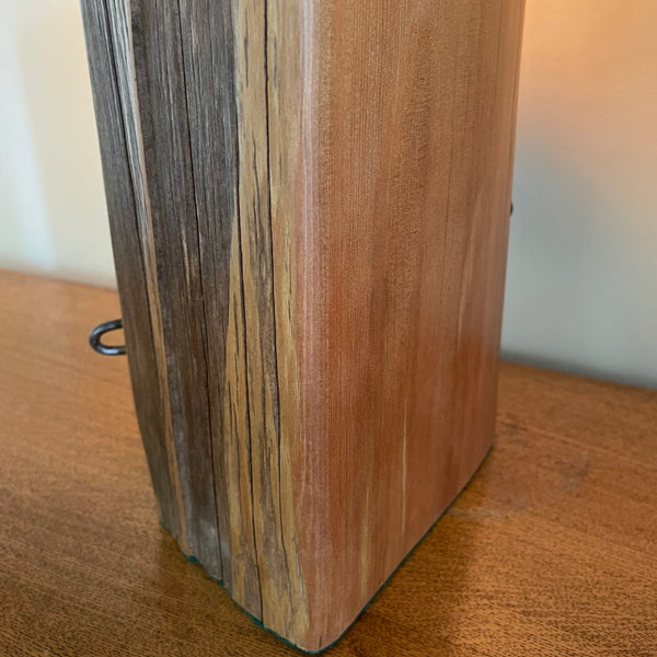 Close up of bees wax polished edge of unique wooden table lamp, handcrafted from old totara post.