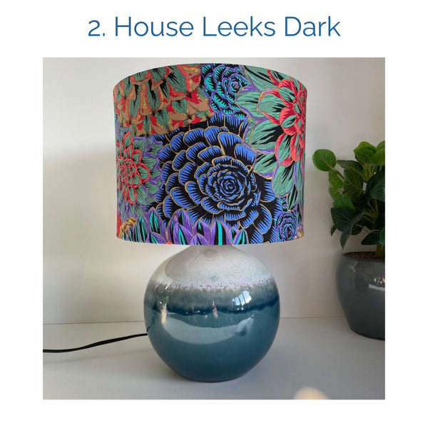 House Leeks Dark fabric lampshade on blue ceramic base, unlit, by shades at grays.