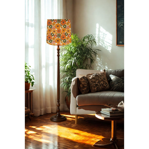 Large tapered lampshade by shades at grays in mid century flower power fabric, on tall floor stand in lounge setting.
