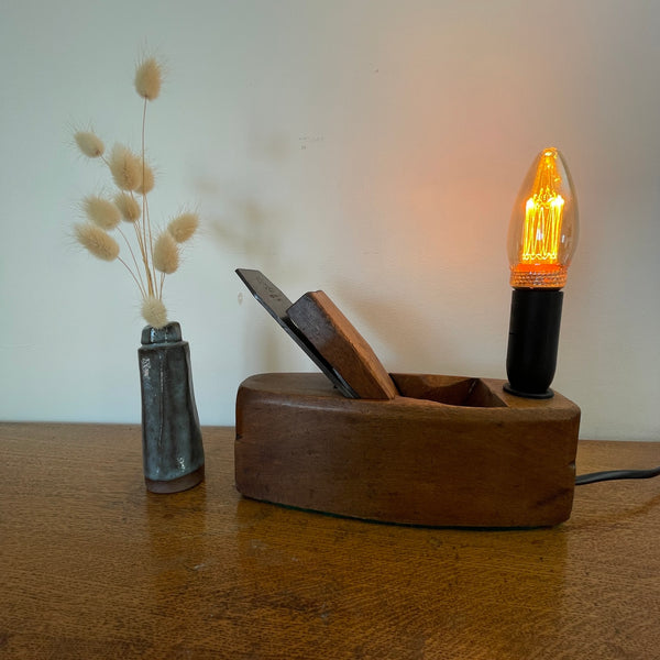Authentic carpenter's plane upcycled into heritage lamp by Shades at Grays, front view with E14 candle bulb, lit.