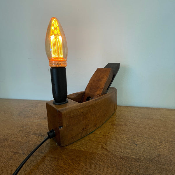 Authentic carpenter's plane upcycled into heritage lamp by Shades at Grays, back and side view with E14 candle bulb, lit.