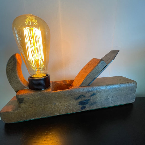 Authentic carpenters plane upcycled into wood lamp with edison lamp, lit.