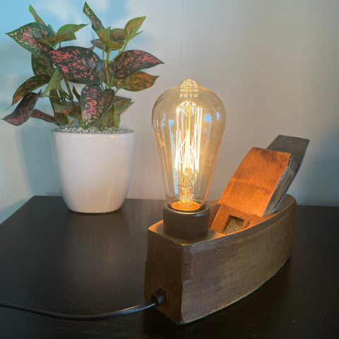 Authentic wood plane table lamp crafted by shades at grays, lit.