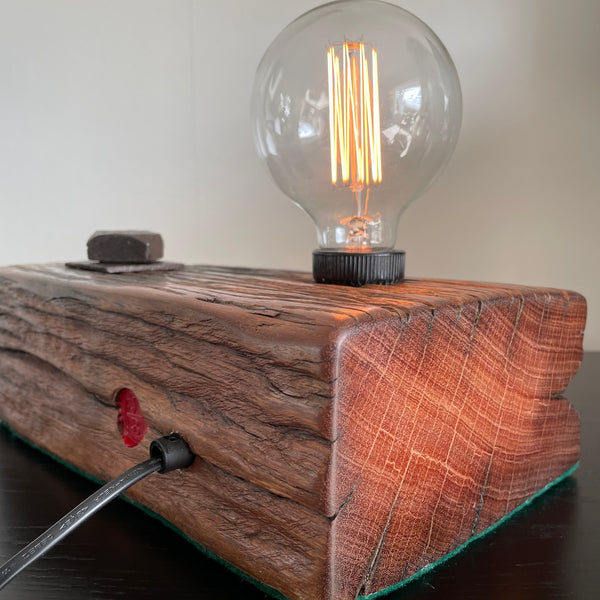 Wooden table lamp upcycled from wharf timber with addition of replica edison bulb, back view with black lead.