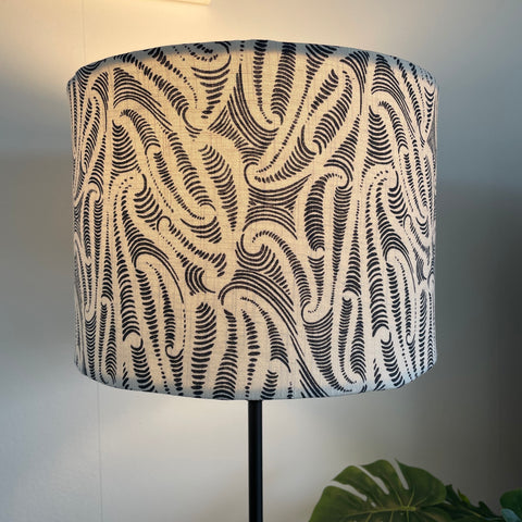 Bespoke medium sized drum lampshade by shades at grays, nz with Aho Creative fabric, lit.