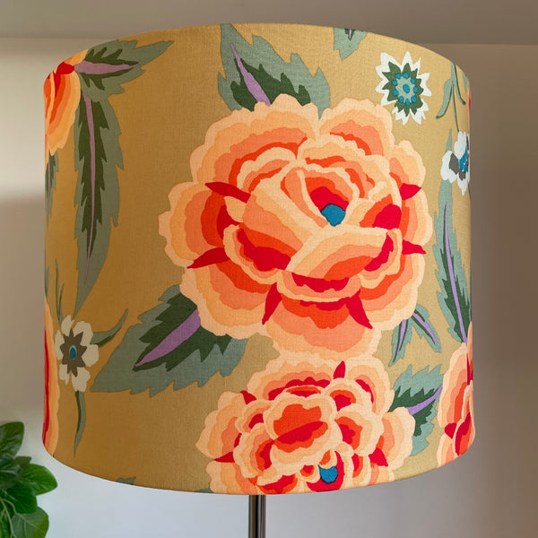Bespoke fabric lampshade with large orange flowers on mustard yellow background by shades at grays nz.