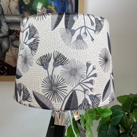 Fabric lampshade with eucalyptus blossom pattern, lit.