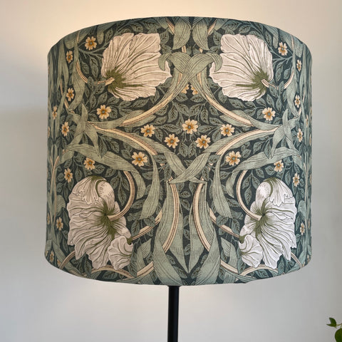 Bespoke medium size drum lamp shade with William Morris Pimpernel Olive fabric, lit, front view by shades at grays nz.