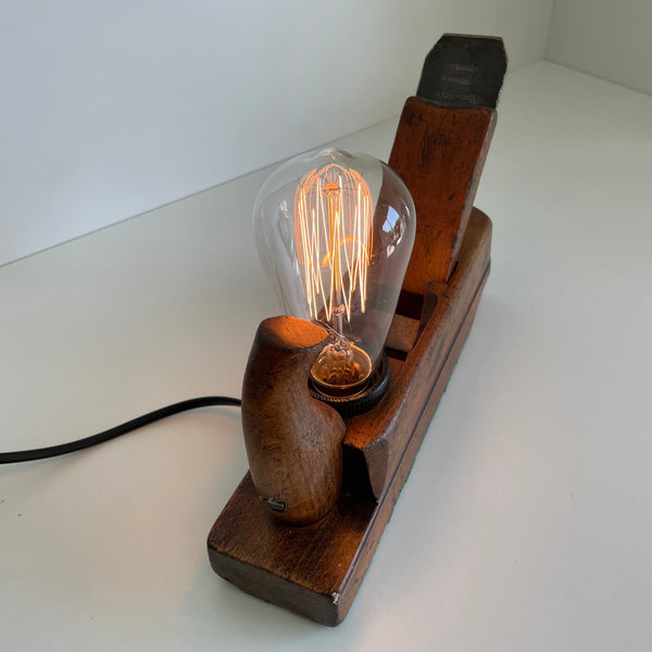 Bismarck handle and edison bulb on wooden table lamp from crafted carpenter's wood plane with edision bulb, lit. Made in Wellington, New Zealand by Shades at Grays