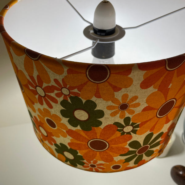 Ceiling pendant handcrafted lampshade  by shades at grays with mid century flower power fabric, lit.