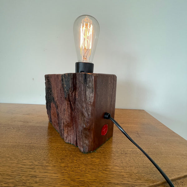 Reclaimed century old wharf timber table lamp created by Shades at Grays, side and back view with edison bulb lit. 