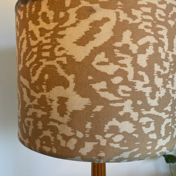 Close up, Large drum hand crafted lamp shade, golden leopard mini fabric, made by shades at grays, new zealand, lit.