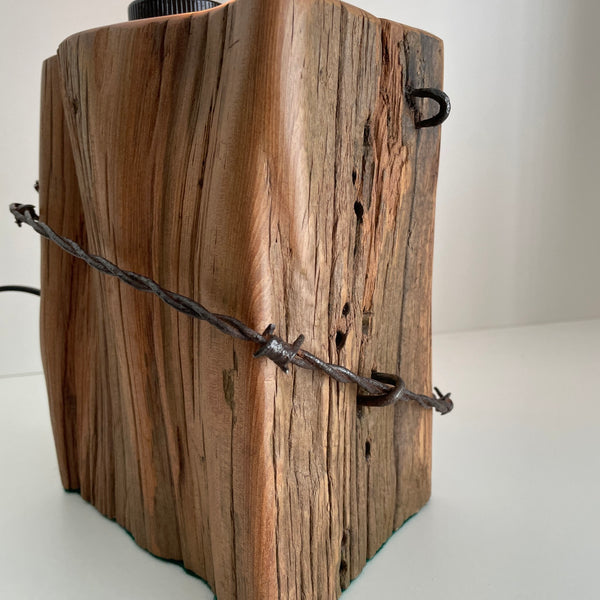 Close up, Wooden table lamp handcraafted from totara post with original fence wire, handcrafted by shades at grays in wellington, nz.