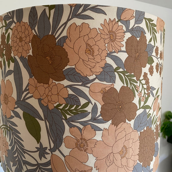 Close up of Large drum lamp shade made in nz by shades at grays, mid century brown floral print, unlit.