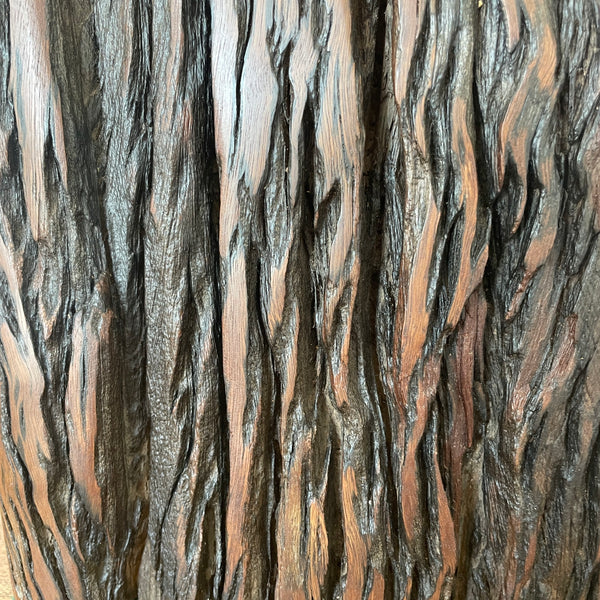 Close up of natural eroded grooves in reclaimed wood table lamp.