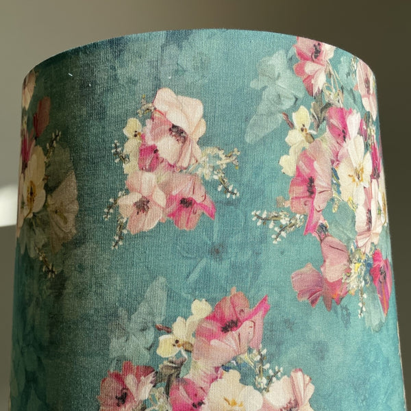 Close up of pretty pink and white flowers on blue background, handcrafted fabric lamp shade.