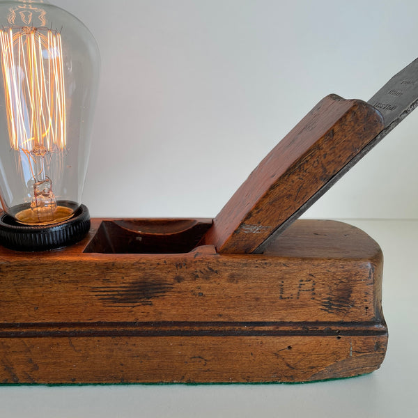 Close up of wooden table lamp from crafted carpenter's wood plane with edision bulb, lit. Made in Wellington, New Zealand by Shades at Grays