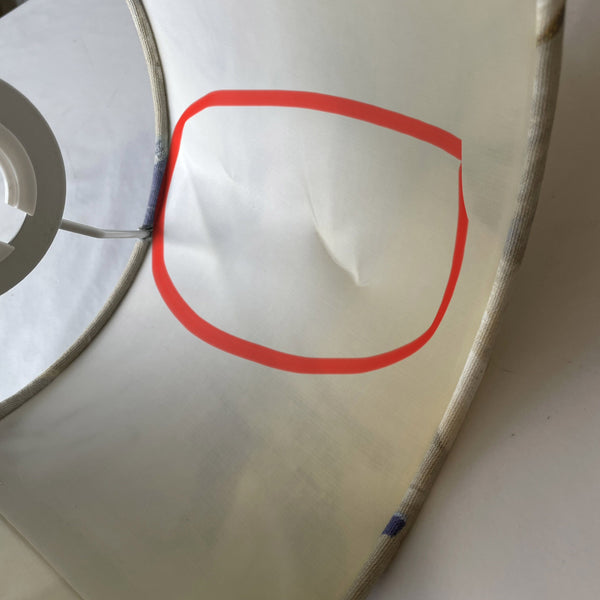 Close up in bright light of ding in inner white lining.