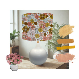 Drum lampshade handcrafted by shades at grays with boho floral garden fabric on white table lamp.