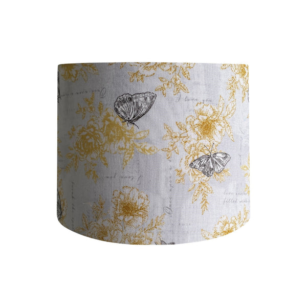 Drum lampshade with summer romance fabric with yellow flowers, black etched butterflies on a white background, handcrafted by shades at grays.
