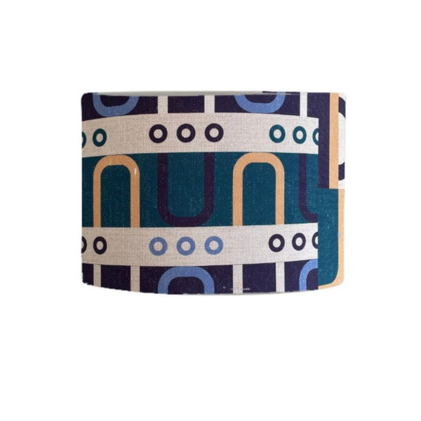 Drum style lampshade with geometric harmony blue fabric.