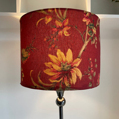 Drum style lamp shade with golden harvest on red fabric, lit, handcrafted by shades at grays, nz