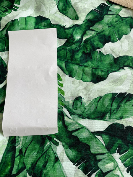 Fabric sample showing pepperminty green background with white paper for contrast.