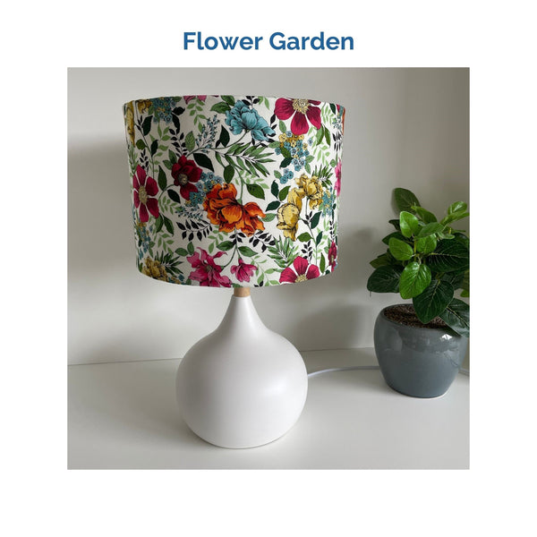 Flower garden fabric on white touch lamp, unlit, crafted by shades at grays.