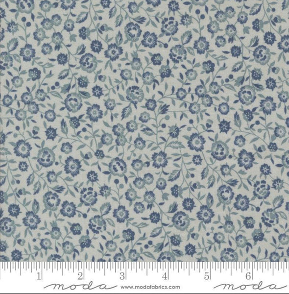 Close up of French General Renoncule fabric in Ciel Blue: a delicate small flower print of tiny French blue blossoms and soft green sprigs on a cream ground.