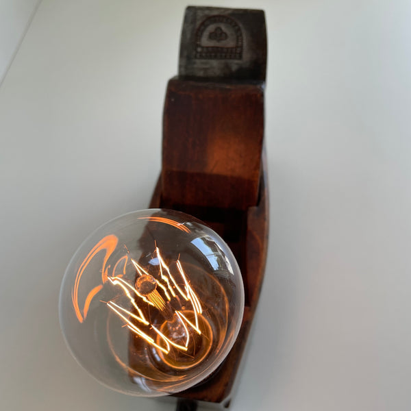 Glow of edison bulb on vintage table lamp.