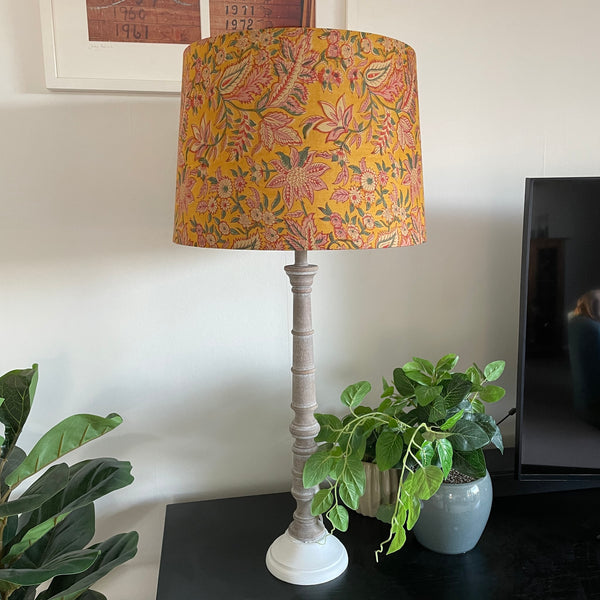 Golden hues fabric on tapered 46 size lampshade, on tall grey wood table lamp, unlit, handcrafted by shades at grays.