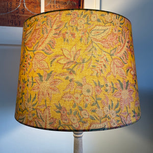 Golden hues fabric on tapered 46 size lampshade, lit, handcrafted by shades at grays.