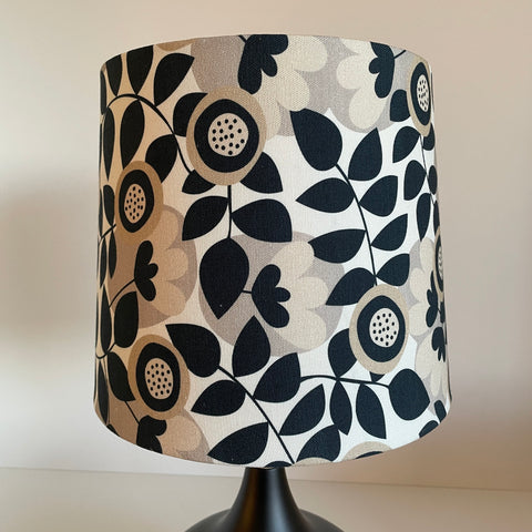 Handcrafted lampshade by shades at grays with graphic bloom fabric, unlit.