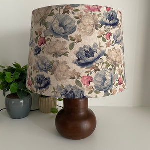 Handcrafted large tapered lampshade with blossoms on grey fabric, unlit, on brown base by shades at grays.