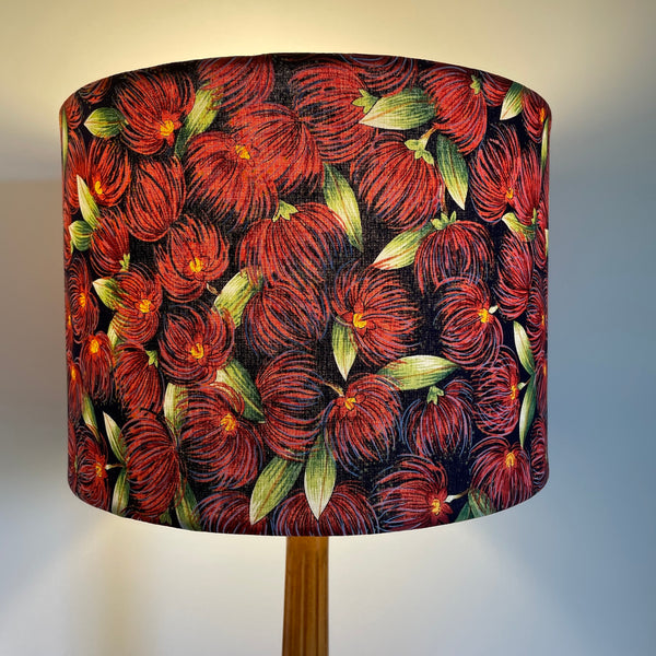 Handcrafted drum lamp shade with pohutukawa fabric, lit.