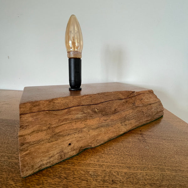 Handcrafted heritage lamp by shades at grays using a reclaimed jarrah beam with additional candle bulb, unlit, angled view.