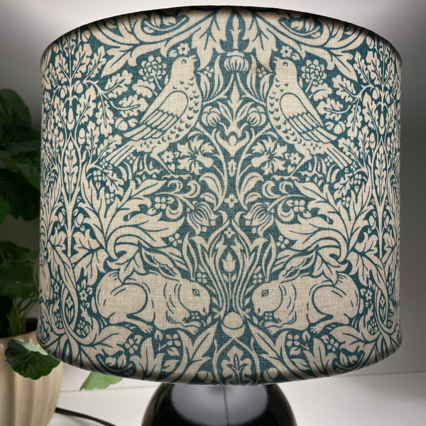 Hnadcrafted lampshade, medium drum with William Morris Brer Rabbitt fabric, lit, by shades at grays nz.