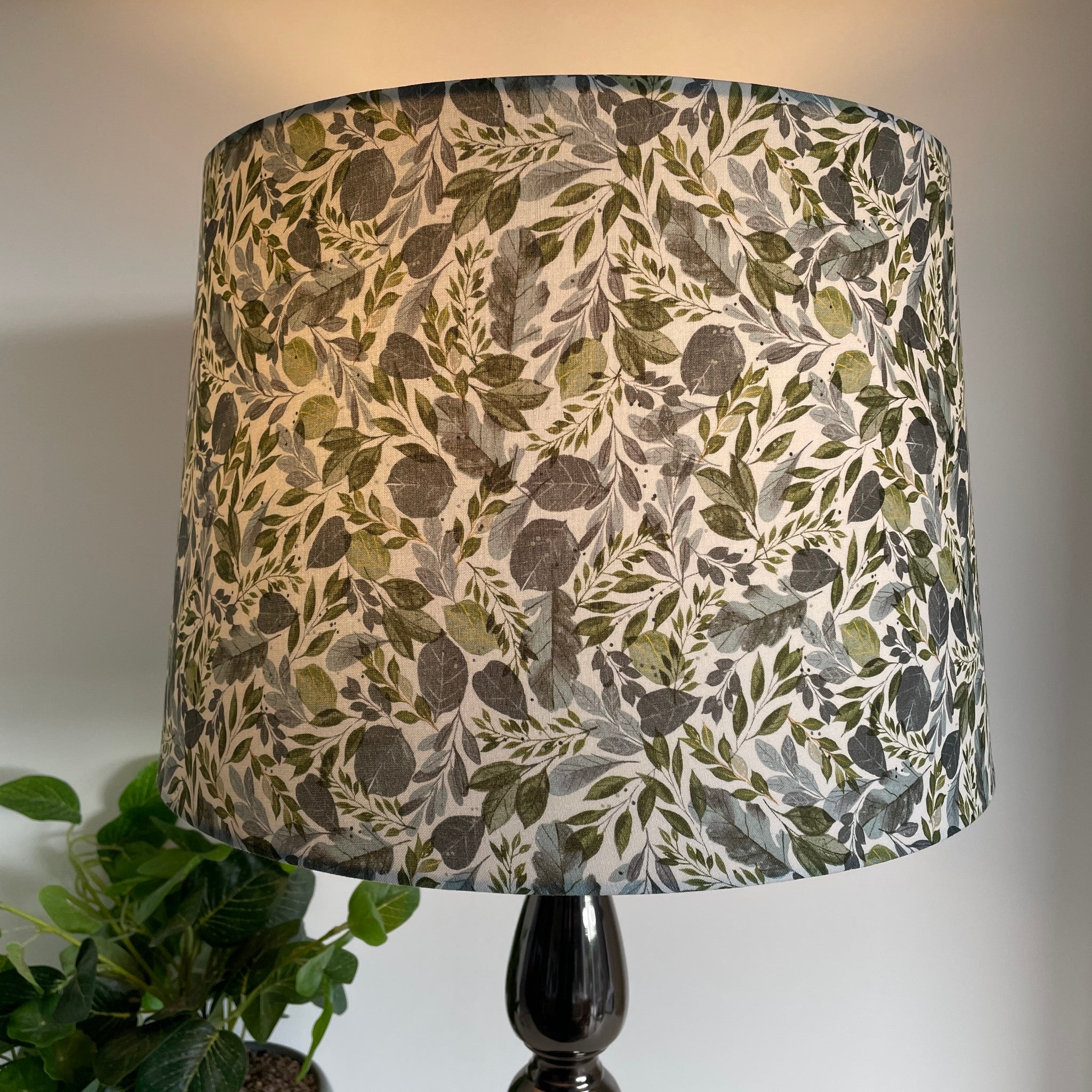 Handcrafted lampshade with Serenity Leaves fabric, tapered 38 shade size, by shades at grays, lit.