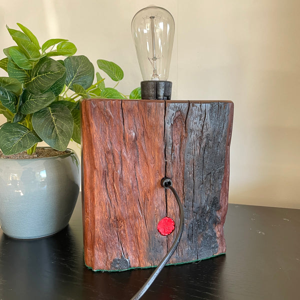 Hand crafted wood lamp created from reclaimed wharf timber, by shades at grays, back view with black lead.