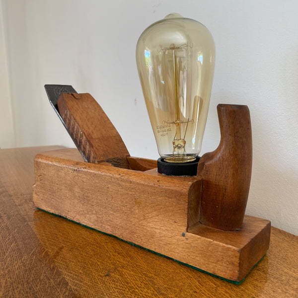 Handmade vintage wood plane lamp by Marples and Sons featuring a warm Edison bulb and polished beech wood base, unlit.