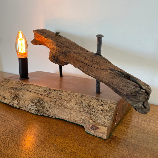 Heritage table lamp crafted by shades at grays from wharf timber, with copper detail on right side.