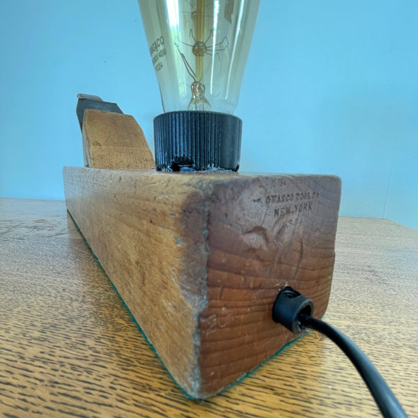 Heritage lamp crafted by shades at grays from original carpenters' half jack plane with replica edison bulb, unlit, back and right side view.