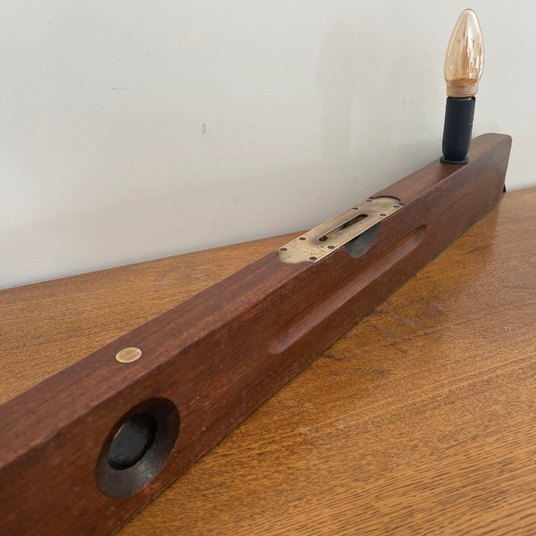 Heritage lamp from long builder's level with added light bulb, unlit, long side view, upcycled by shades at grays.