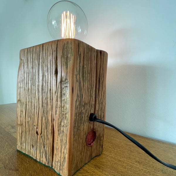 Heritage lamp upcycled by shades at grays, of Totara fencepost with wide lined front with several staple holes, back view.