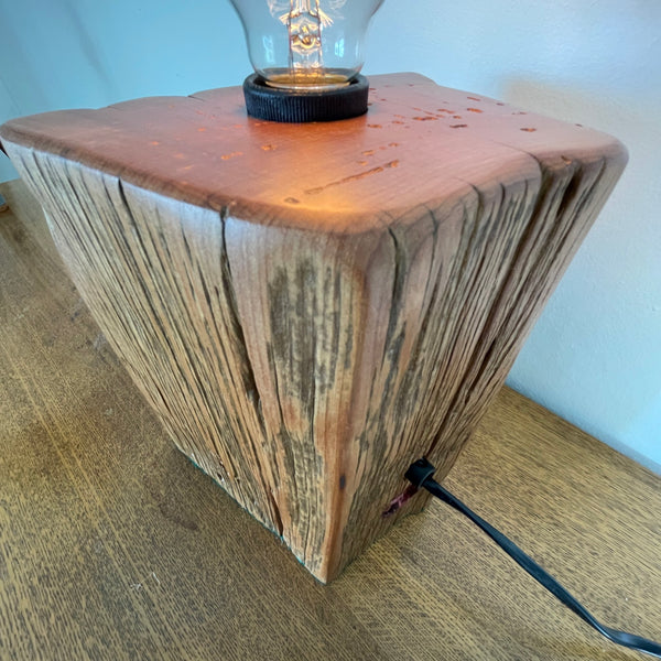 Heritage lamp upcycled by shades at grays, of Totara fencepost with wide lined front with several staple holes, top and side view.