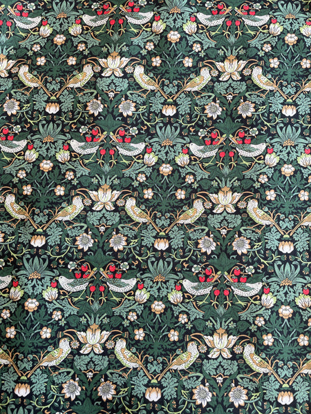 Pattern swatch of william morris strawberry thief green fabric, with birds and berries.